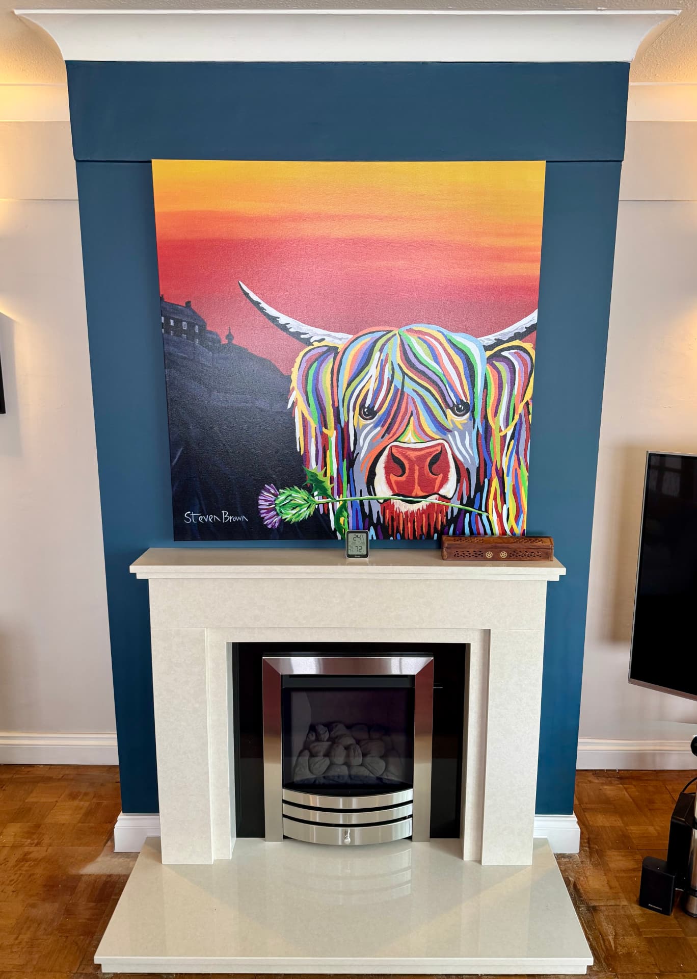 Deep teal chimney-breast feature wall framing artwork in a Reading sitting room